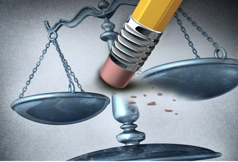 A pencil eraser pressing down on the scales of justice, symbolizing the erasure or undermining of law